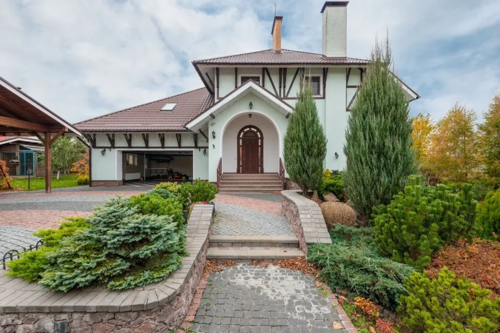 A beautiful suburban house with decorative plants and a paved driveway, representing local business appeal.