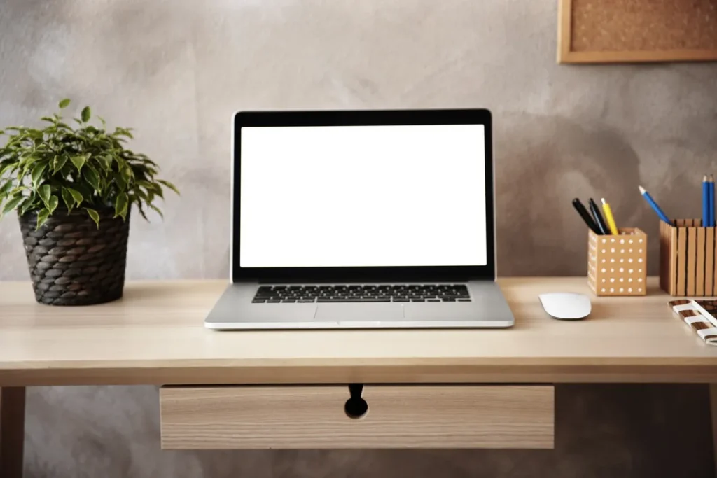 A modern workspace featuring a laptop on a table, symbolizing the digital strategies used in SEO.